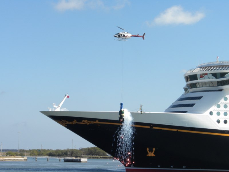 Disney broke the bottle of "Dreams" in style, lifting it off a nearby barge with a helicopter.