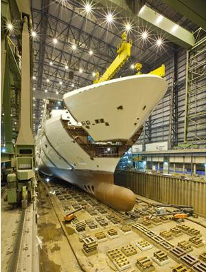 Norwegian Breakaway, under construction at Meyer Werft in Papenburg, Germany achieved another milestone on Wednesday morning when the ship’s bow was lowered into place.