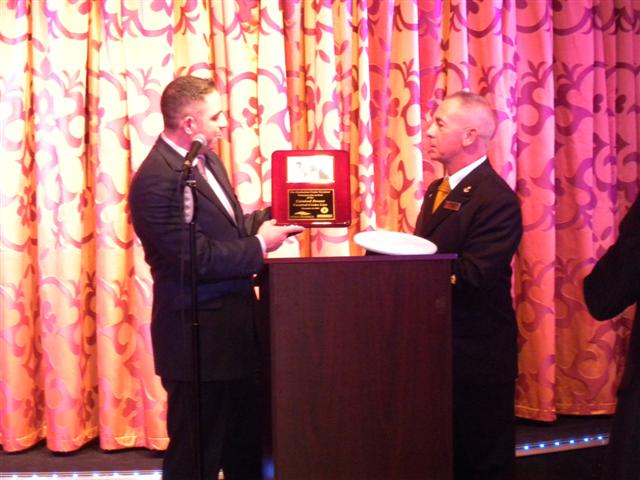 Thomas Spina, director of cruise operations for NYC Cruise, presents a plaque to Captain Carlo Queirolo of the Carnival Dream.
