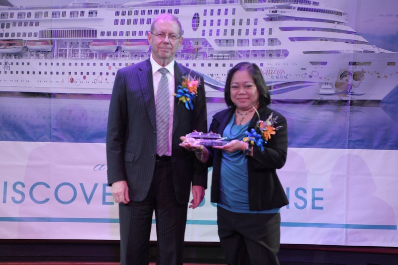 Ms. Maria Corazon Jorda-Apo, Director for Market Development Group of the Department of Tourism (right) received a model crystal ship from Mr. Michael Hackman, Senior Vice President and Country Head—Philippines, Star Cruises (left).